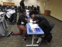 someone is helping two students someone is helping two students