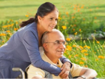 Social Security Disability Determination Woman hugging man in wheelchair in a field