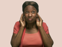 Woman with hands next to her ears Woman with hands next to her ears