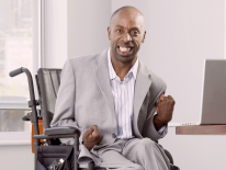 Man in a wheelchair at a computer